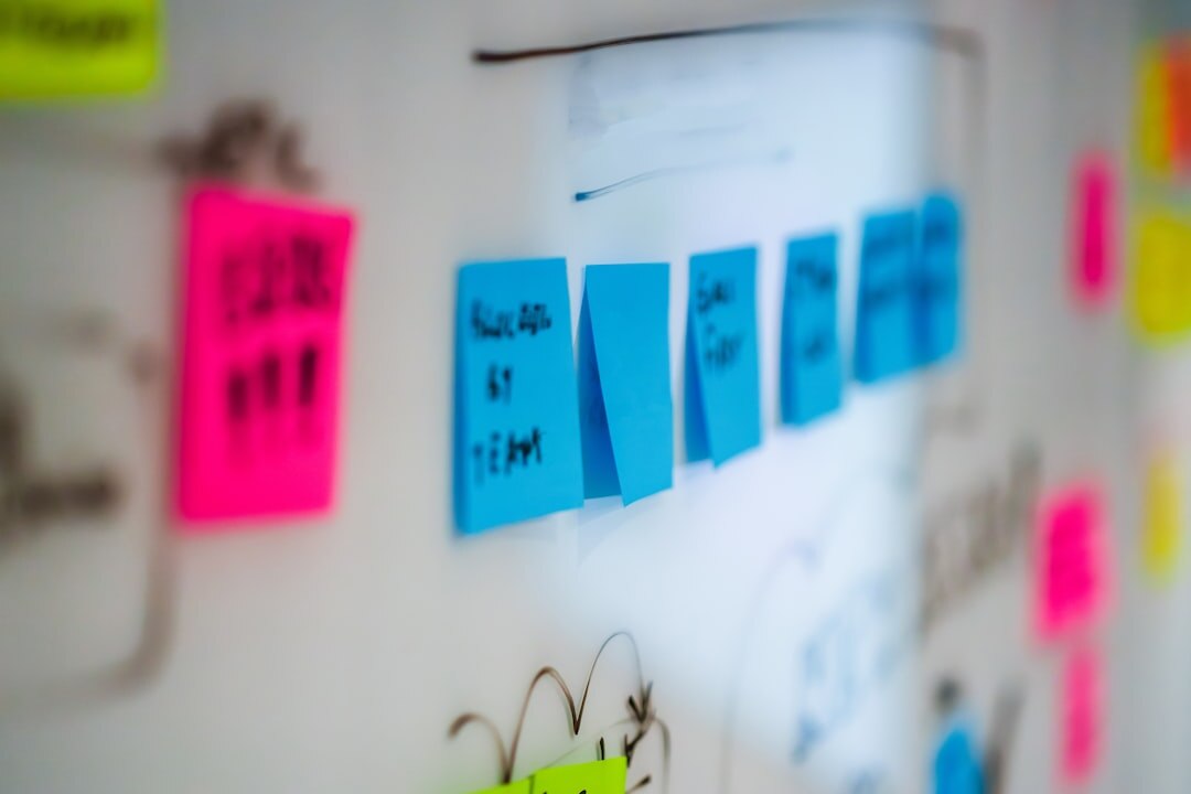 Creative team brainstorming marketing campaign ideas on whiteboard